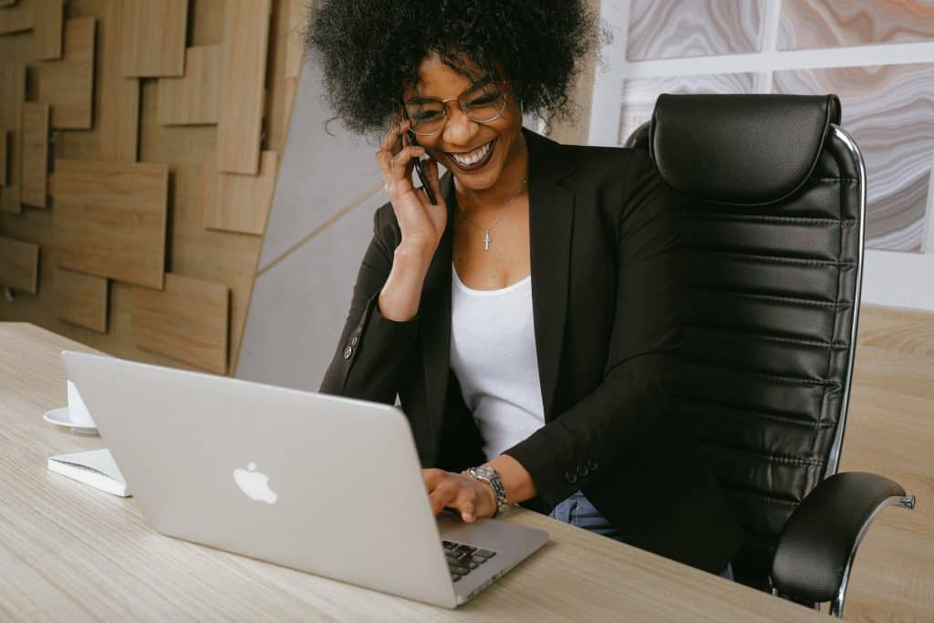 A woman speaking on the phone at her desk