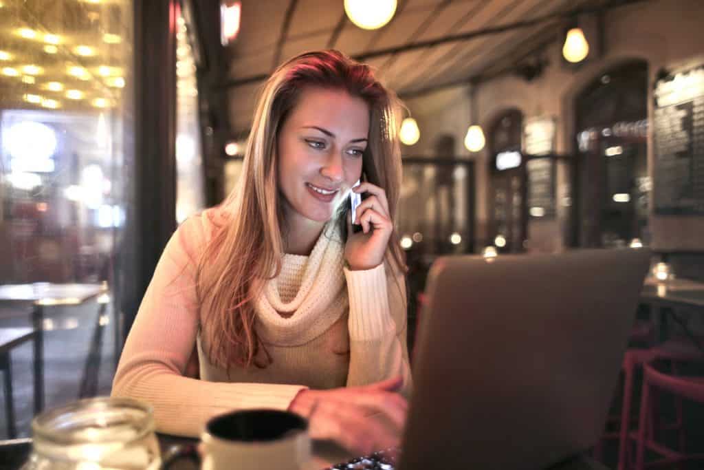 A woman on the phone in a cafe