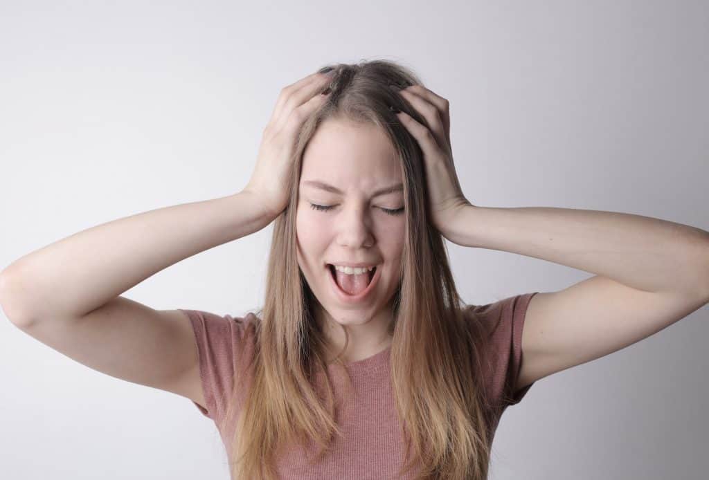 A girl with her hands on her head