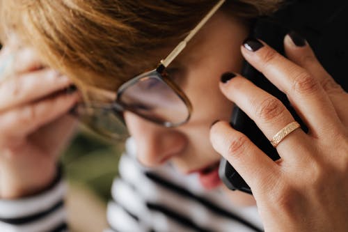 A woman with short hair on the phone