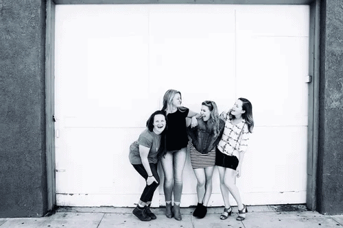 A group of girlfriends posing in a black and white photograph