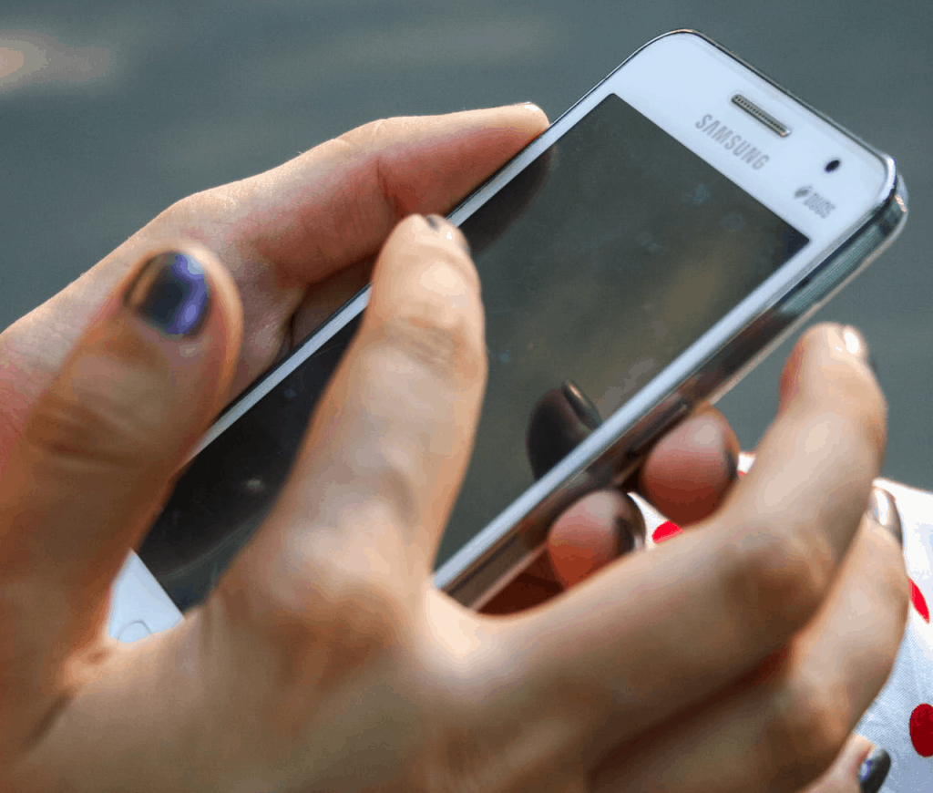 A hand holding a smartphone 