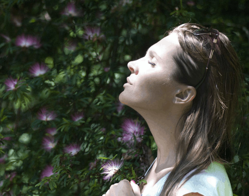 A woman breathing in the fresh nature air