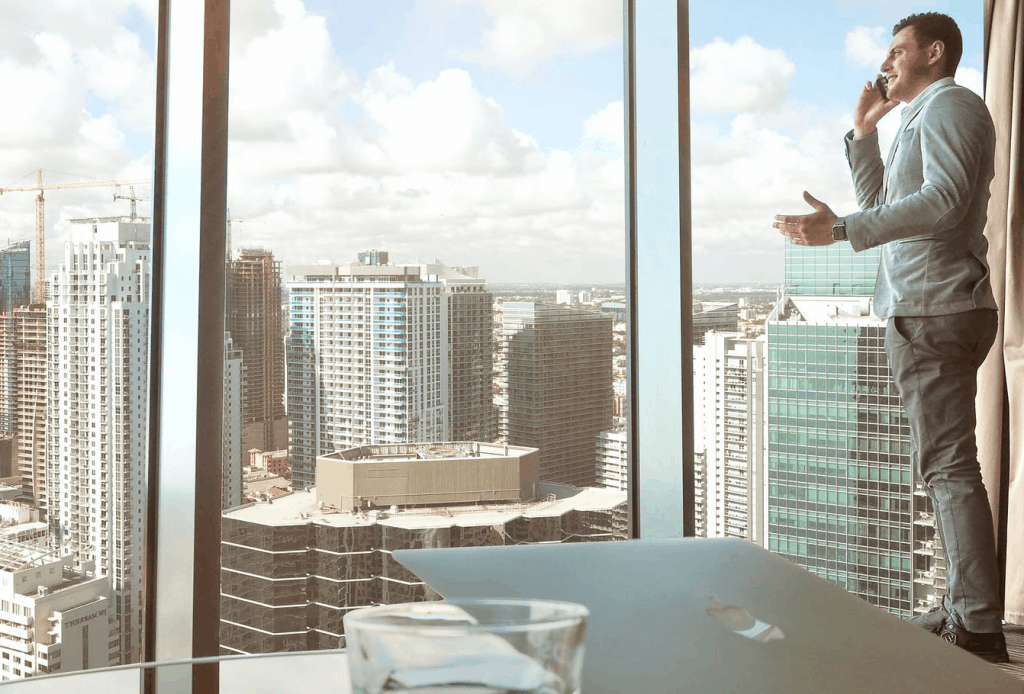 A businessman speaking on the phone by the window