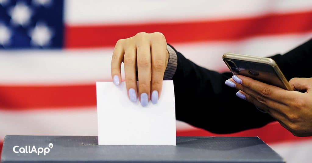 A woman putting her ballot in the vote box 