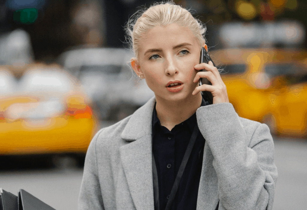 A blonde woman speaking on the phone