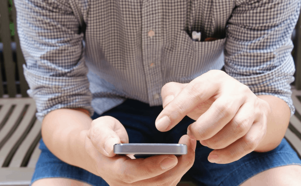 A man holding his phone to see who viewed his profile