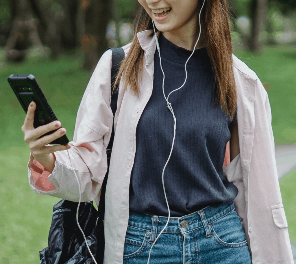 An Asian woman on a video call with headphones