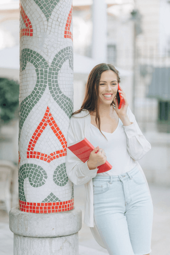 A young woman smiling as she speaks on the phone with Caller ID from CallApp