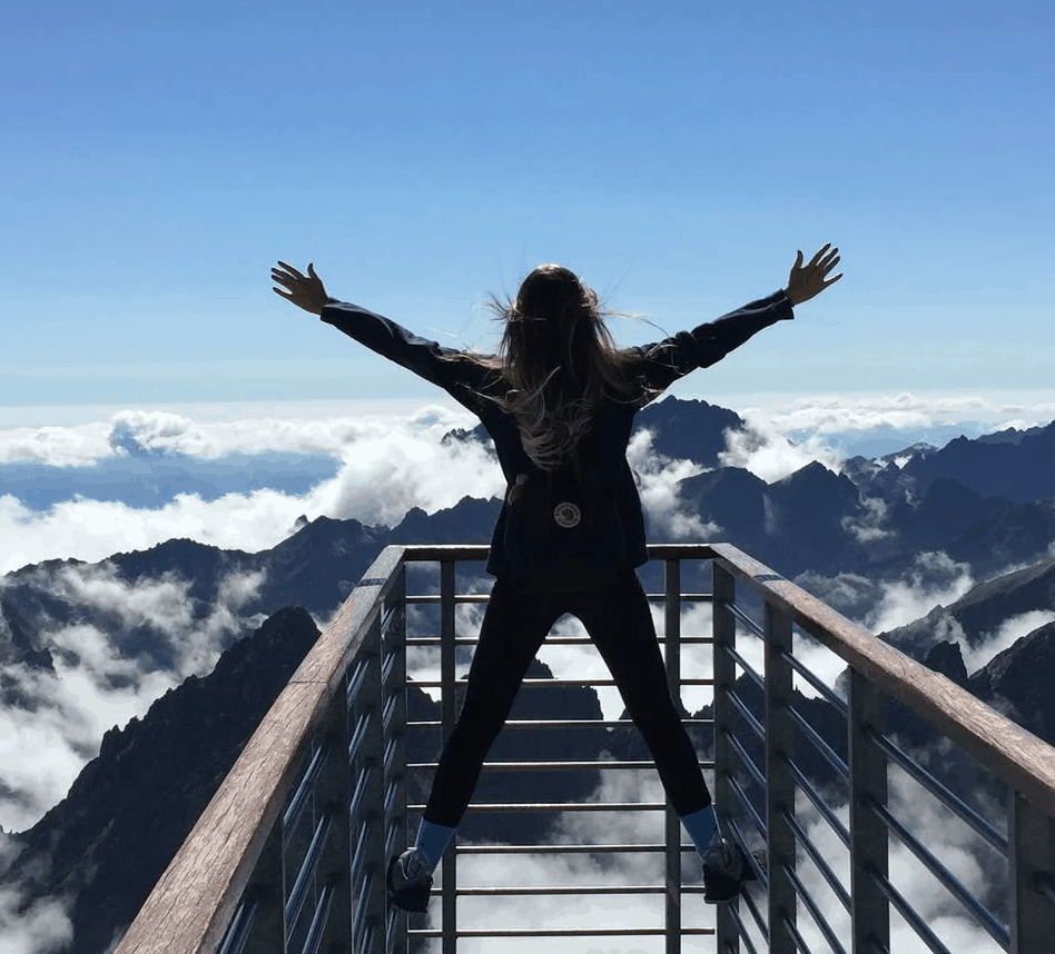 A woman standing in front of a mountain