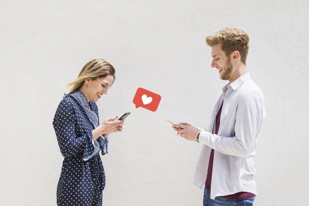 A young couple looking for love on their mobile phones