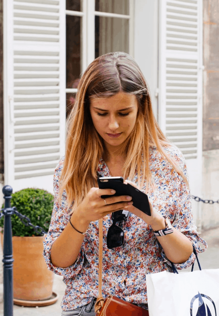 A blonde woman searching a number on CallApp